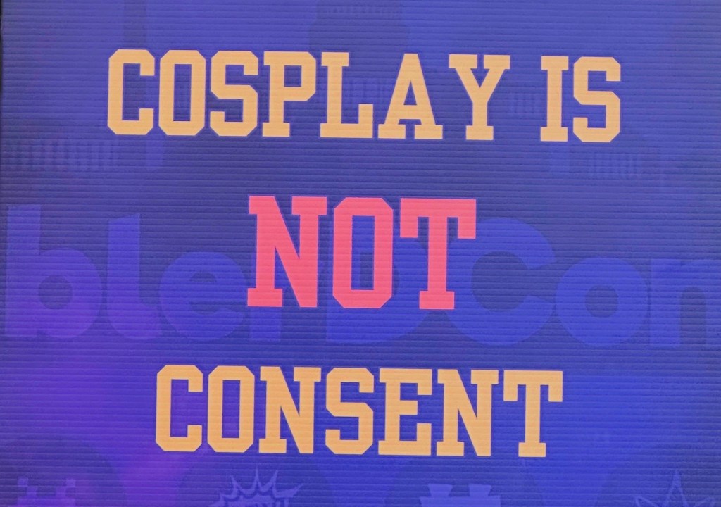 COSPLAY IS NOT CONSENT is depicted on a sign at Blerdcon.